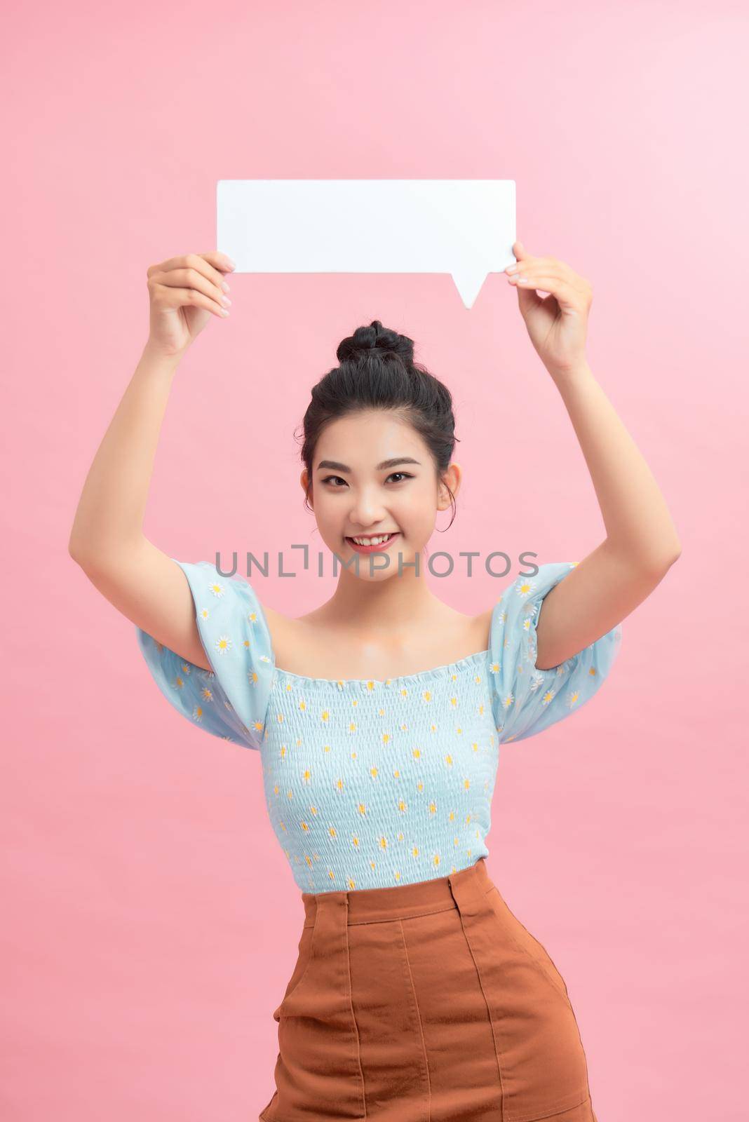 Young girl with speech bubble on pink background by makidotvn