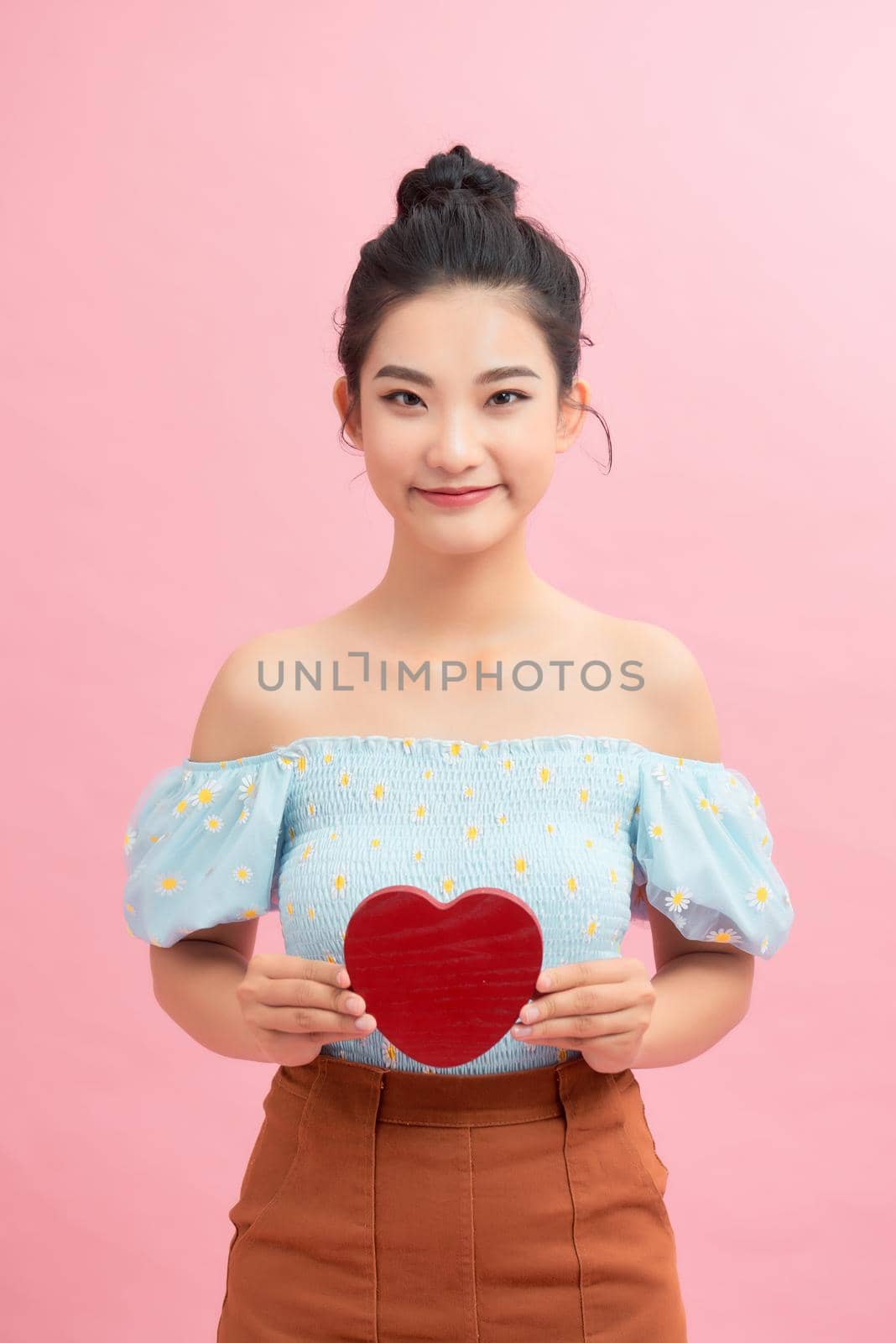 Woman holding paper heart shaped card . Valentine day concept . by makidotvn
