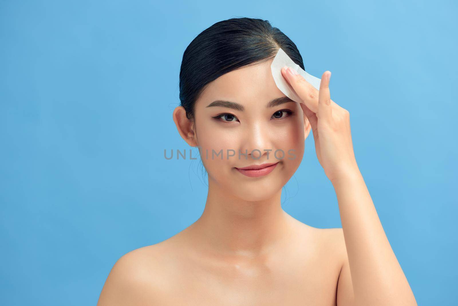 Photo of woman with perfect makeup on blue background. Beauty concept by makidotvn