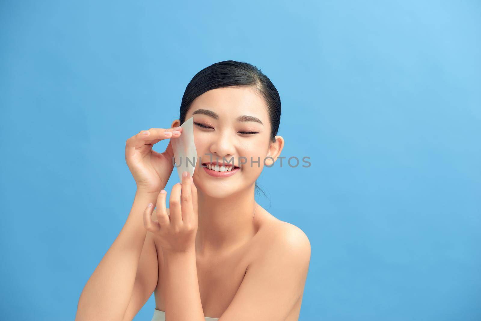 Photo of woman with perfect makeup on blue background. Beauty concept