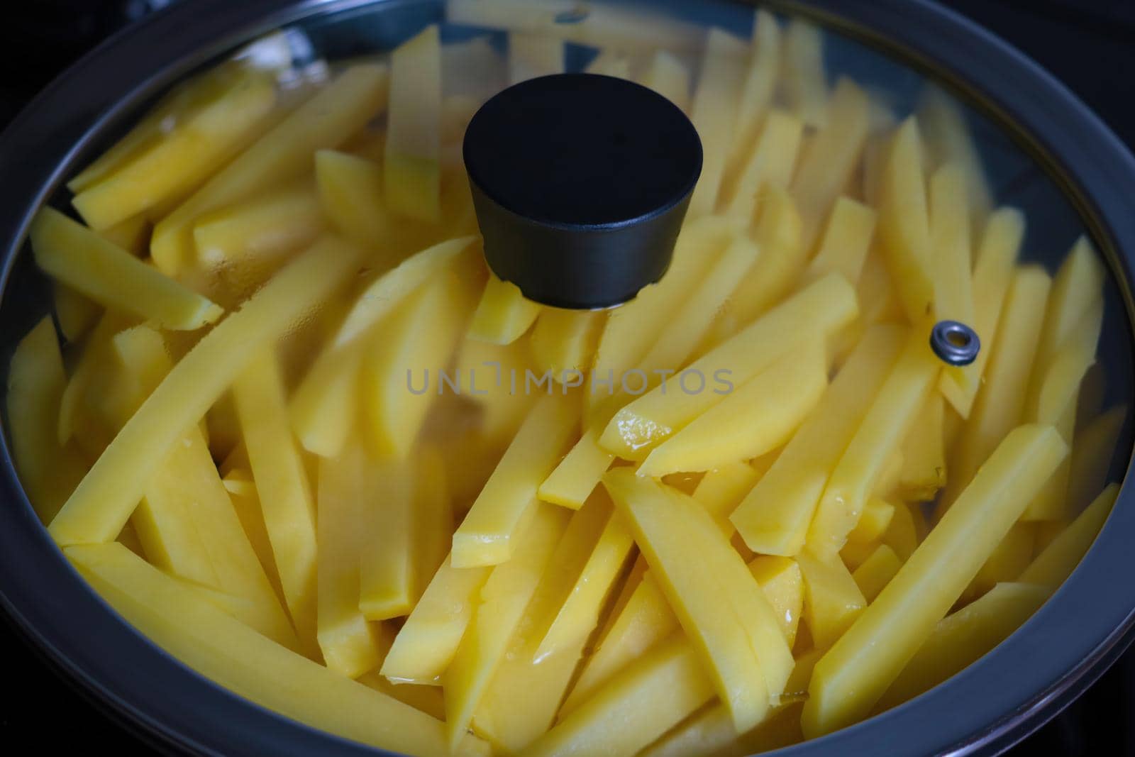 Beautiful yellow potato sliced in a frying pan. by kip02kas