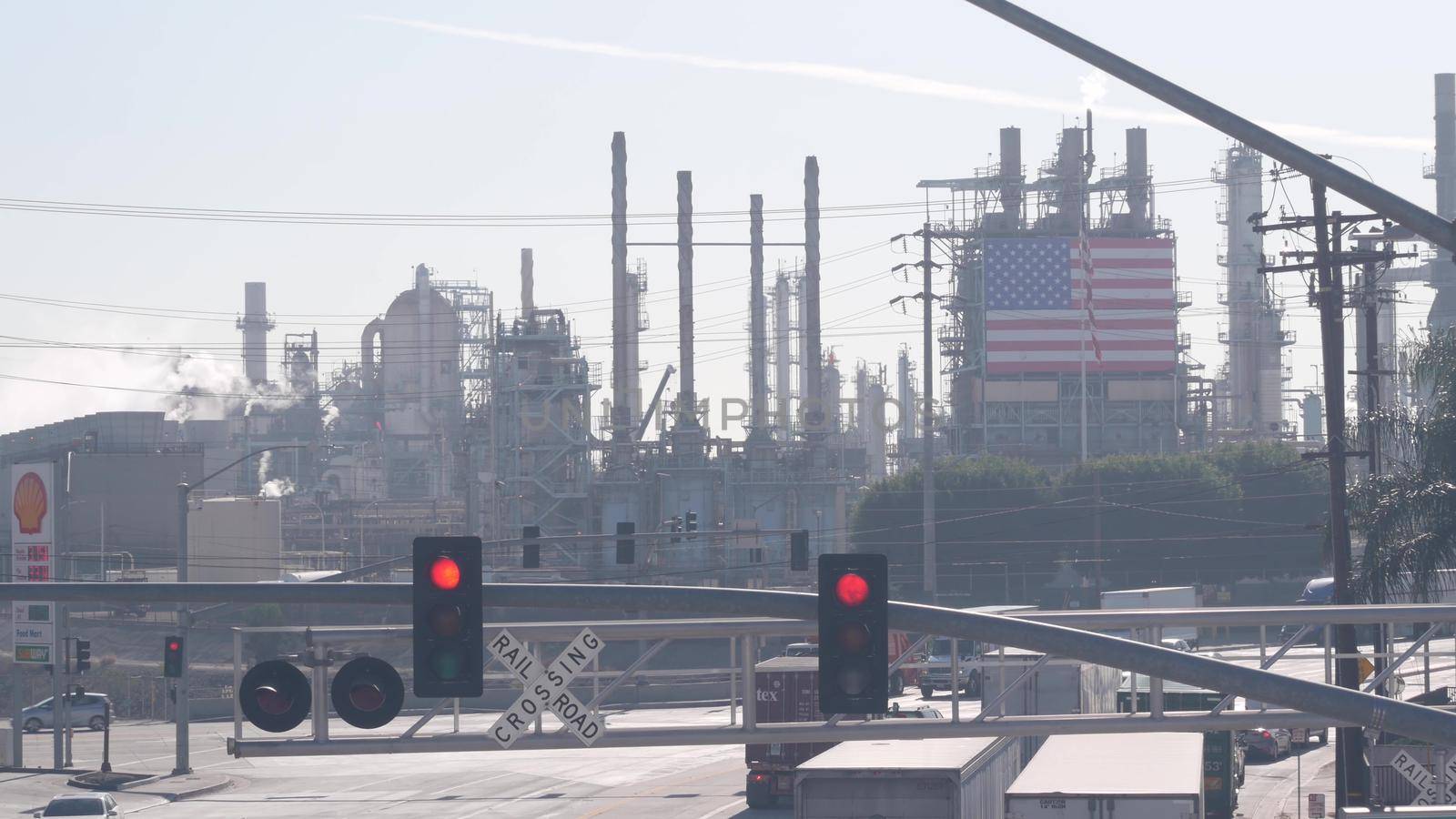 Carson, California, USA - 02 Dec 2020: Marathon oil refinery, Los Angeles. Petroleum, chemicals and gasoline factory. American flag and smokestacks of industrial petrochemicals plant, Wilmington ave.