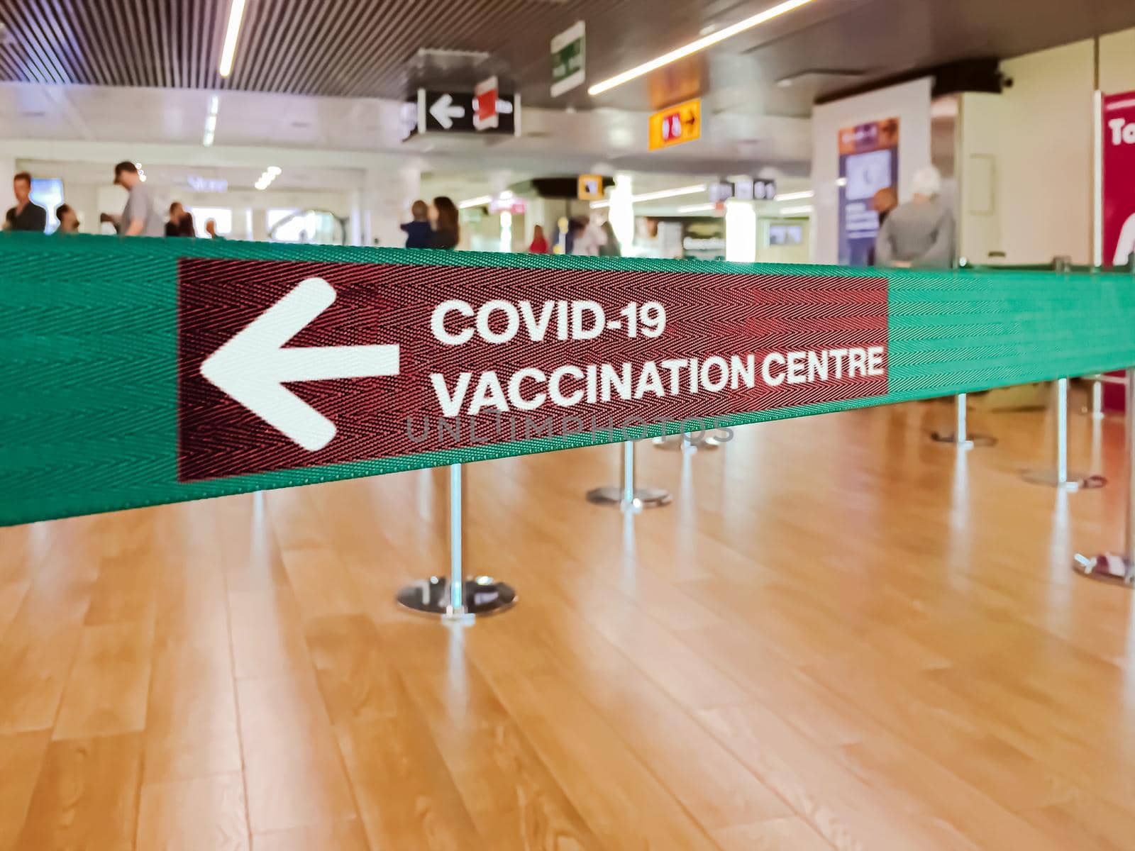 Green ribbon with a left arrow to indicate the Covid-19 vaccination centre by rarrarorro