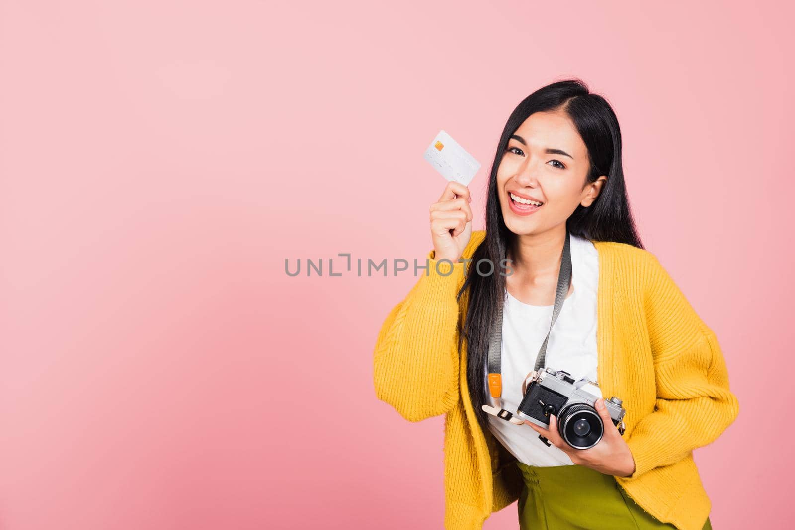 Happy Asian portrait beautiful young woman excited smiling photographer holding credit credit card bank and retro vintage photo camera ready travel isolated on pink background, tourism and vacation