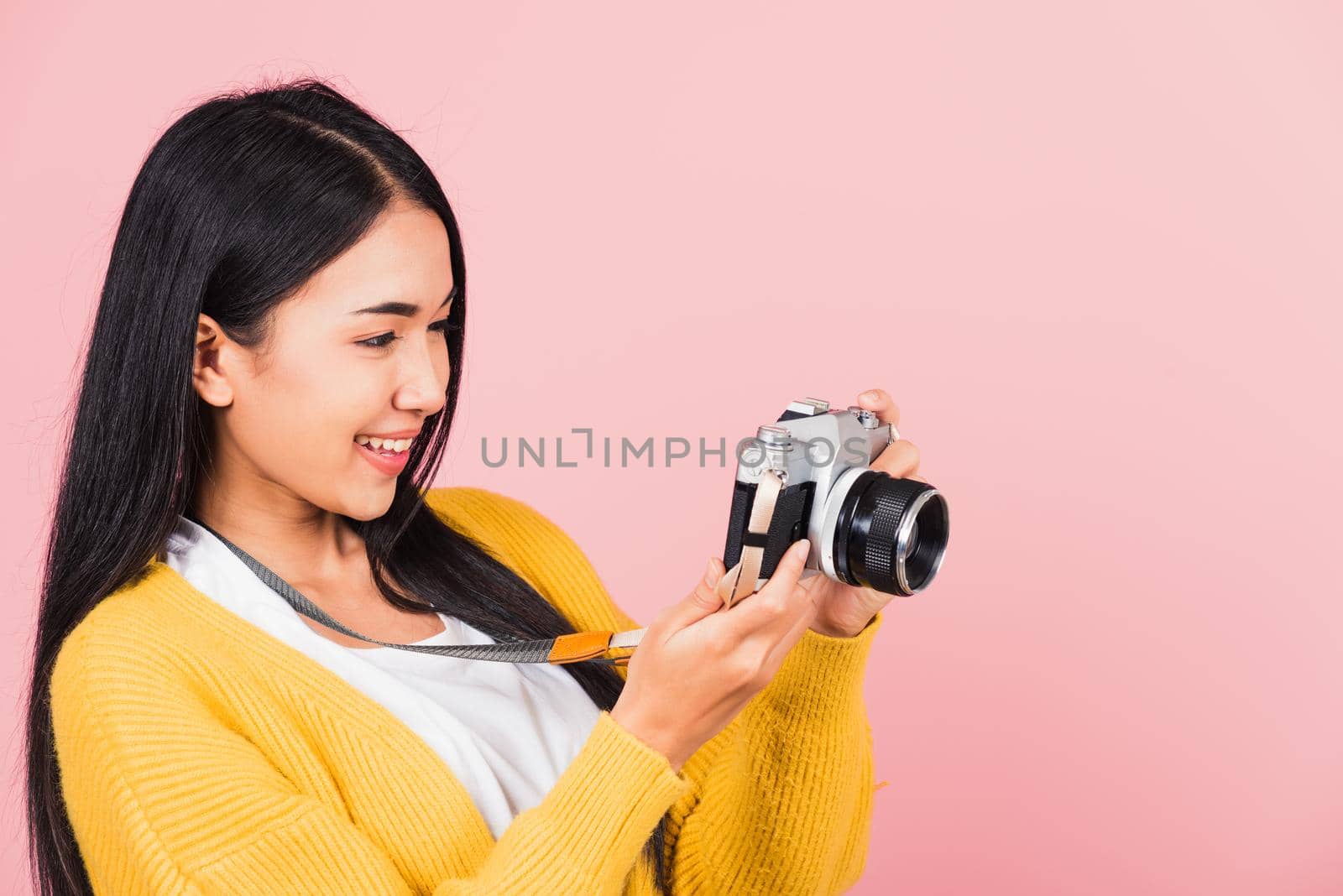 woman teen excited smiling holding vintage photo camera by Sorapop
