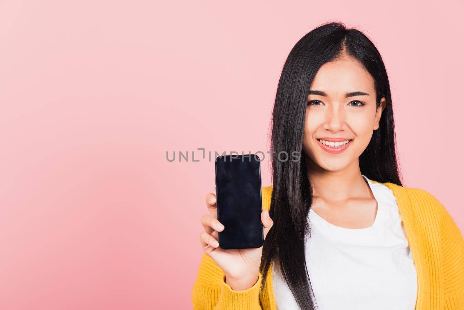 woman teen smiling excited  holding blank screen mobile phone by Sorapop