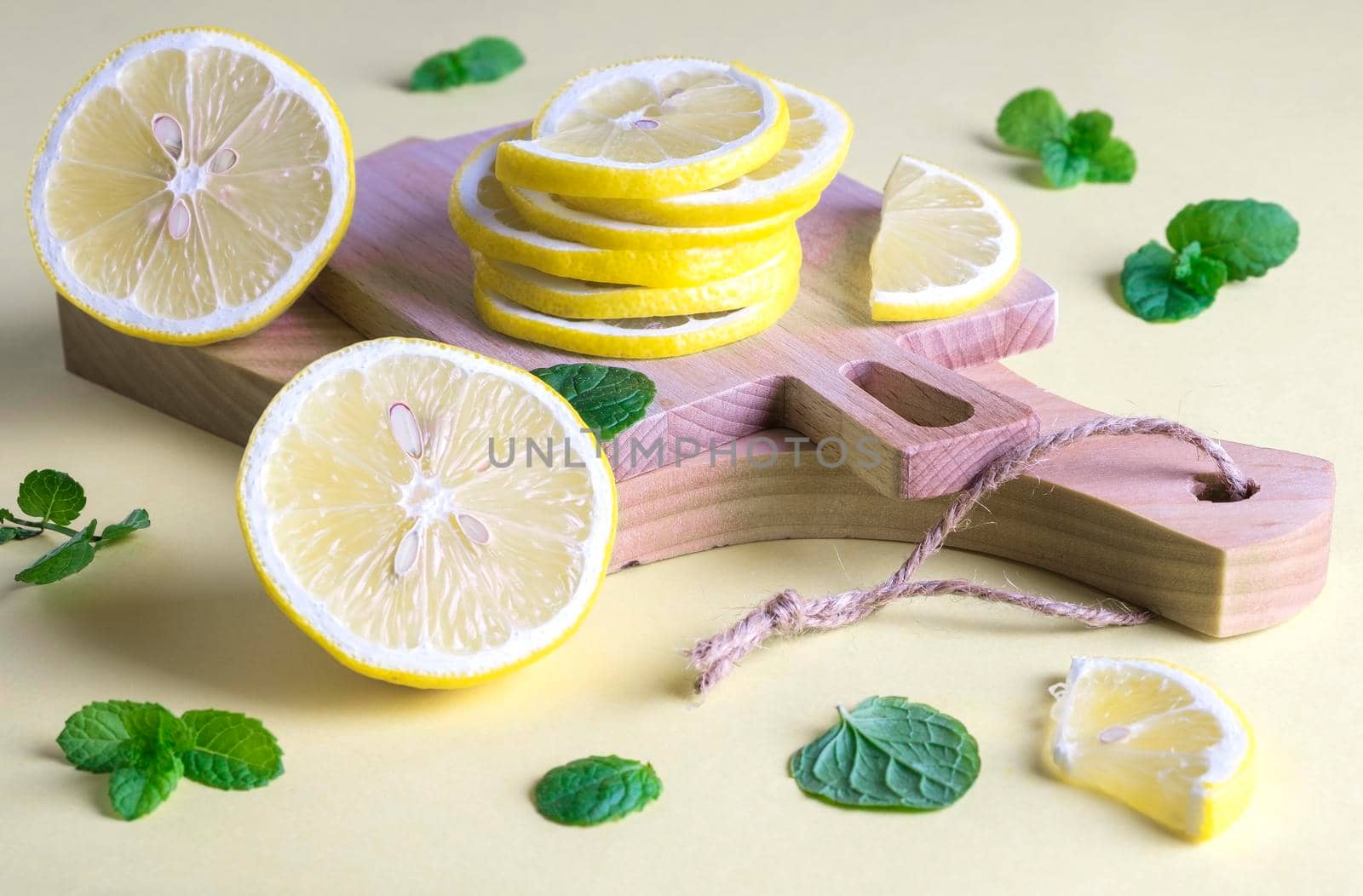 Two small cutting boards with slices of ripe fresh lemon by OlgaGubskaya