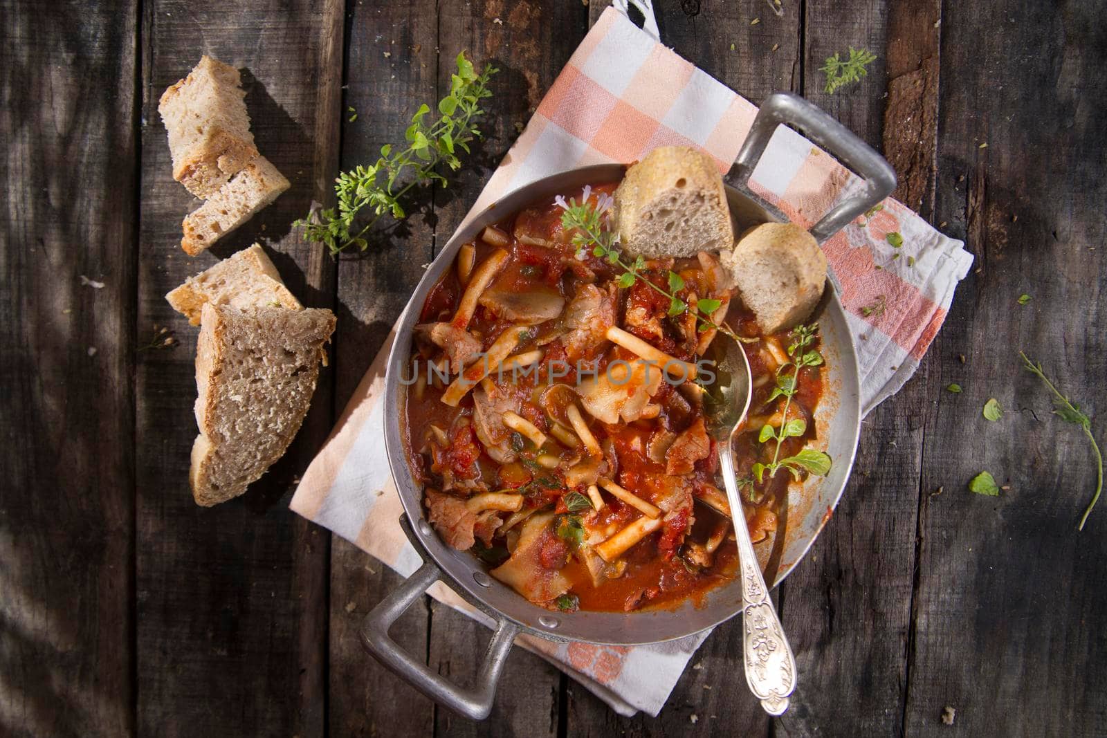 Presentation of a dish with mushrooms pioppini stewed with tomatoes