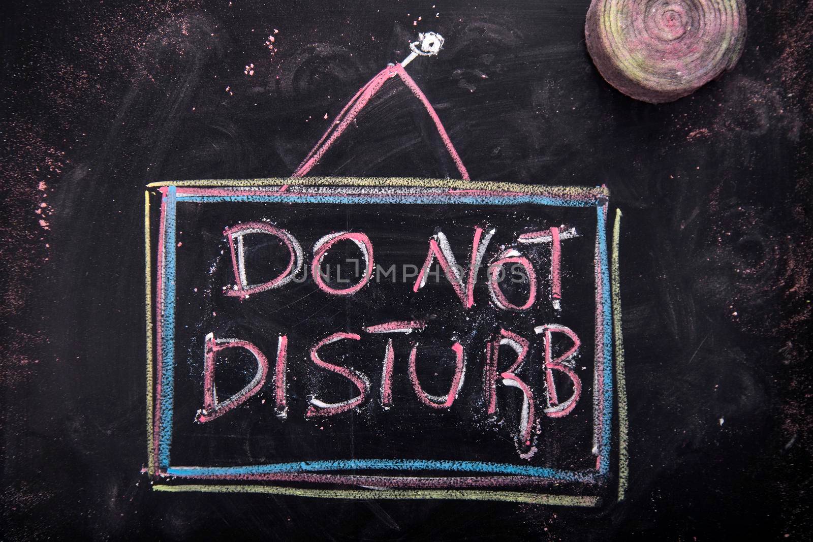 Graphic representation of the word, do not disturb, written with chalk on blackboard