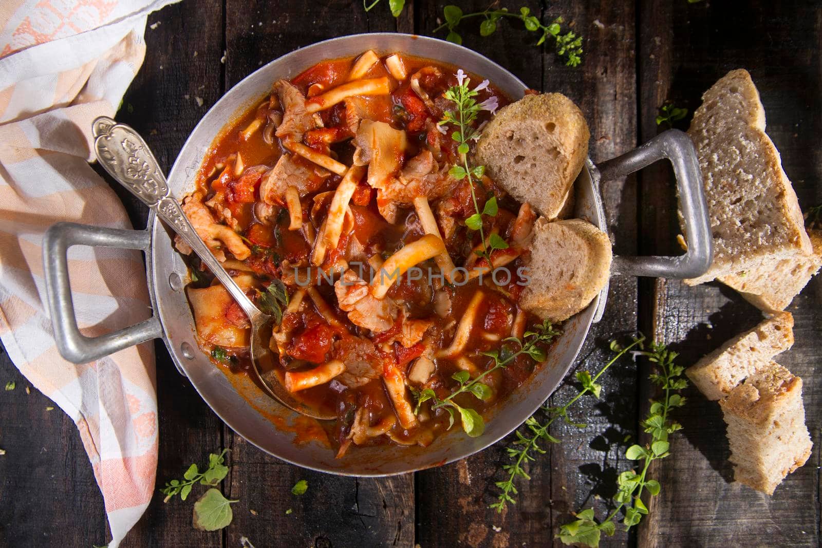 Presentation of a dish with mushrooms pioppini stewed with tomatoes