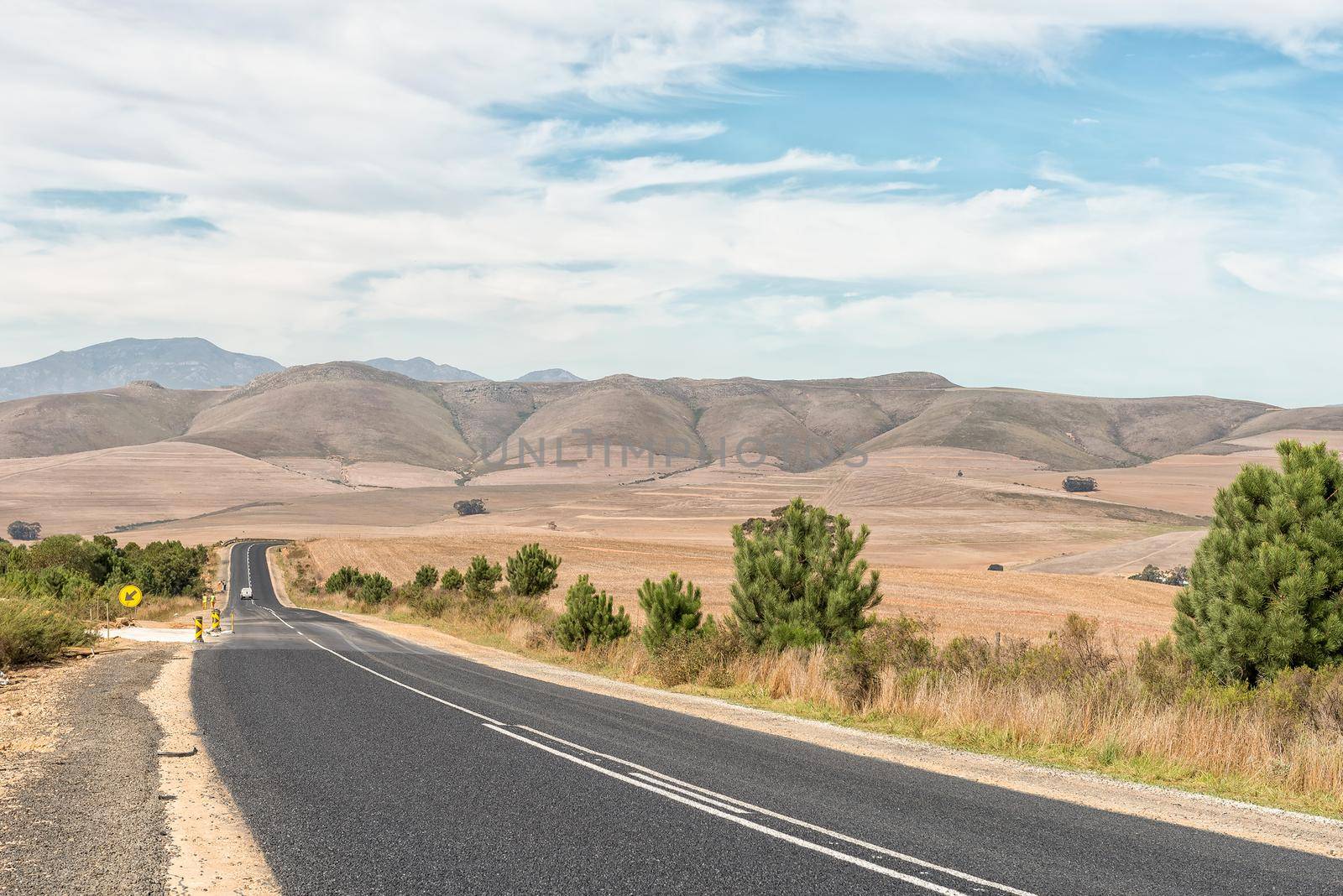 Landscape on road R43 between the Theewaterskloof dam and road N2 in the Western Cape Province. Road workers are visible