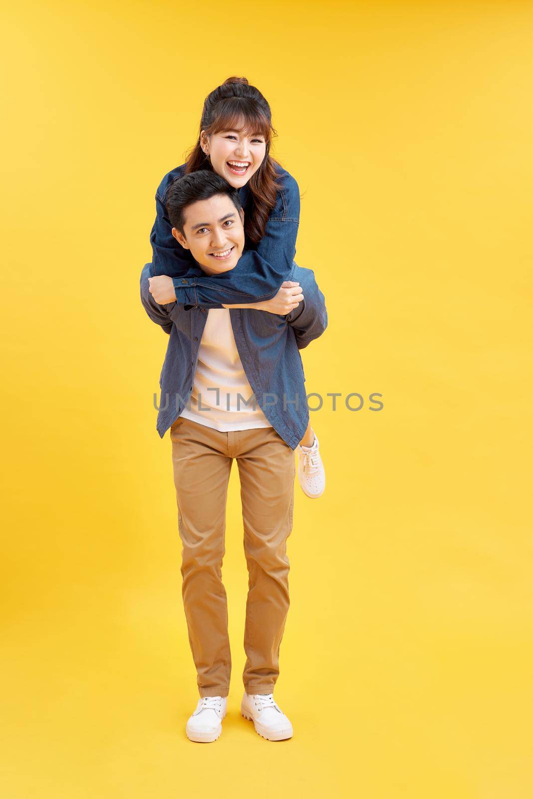 Profile photo of amazing guy and lady holding piggyback playing leisure game wear casual jeans clothes isolated grey color background by makidotvn