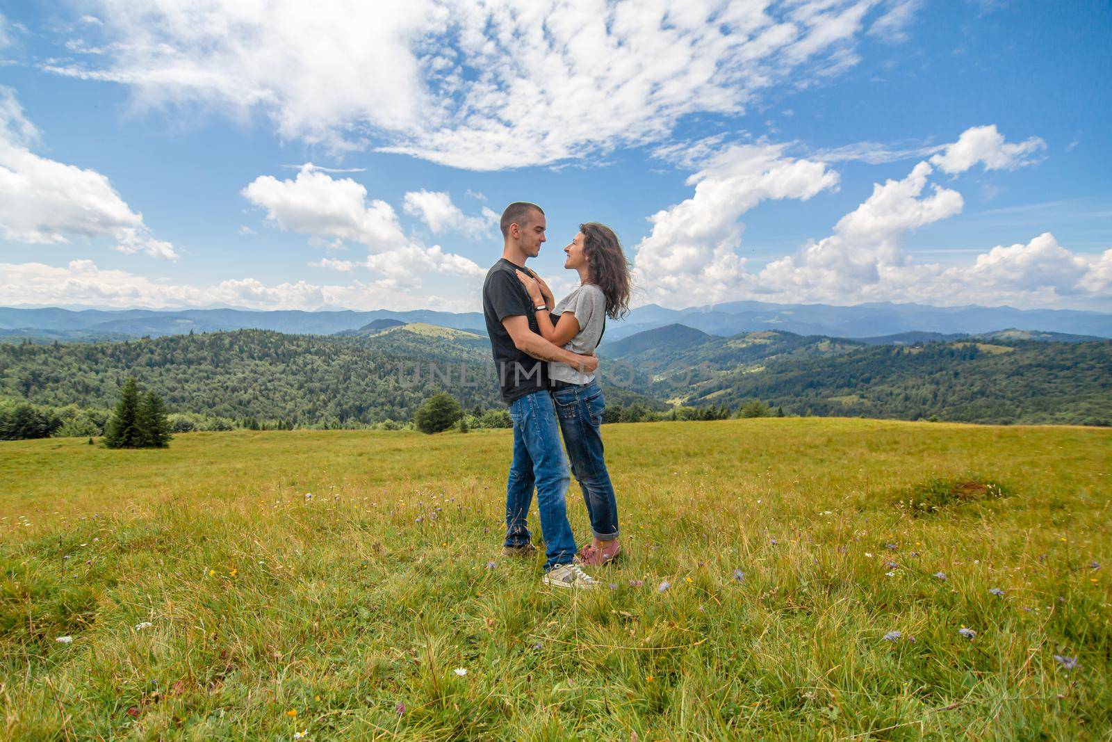 Young couple hugs on amazing mountain landscape background by Try_my_best