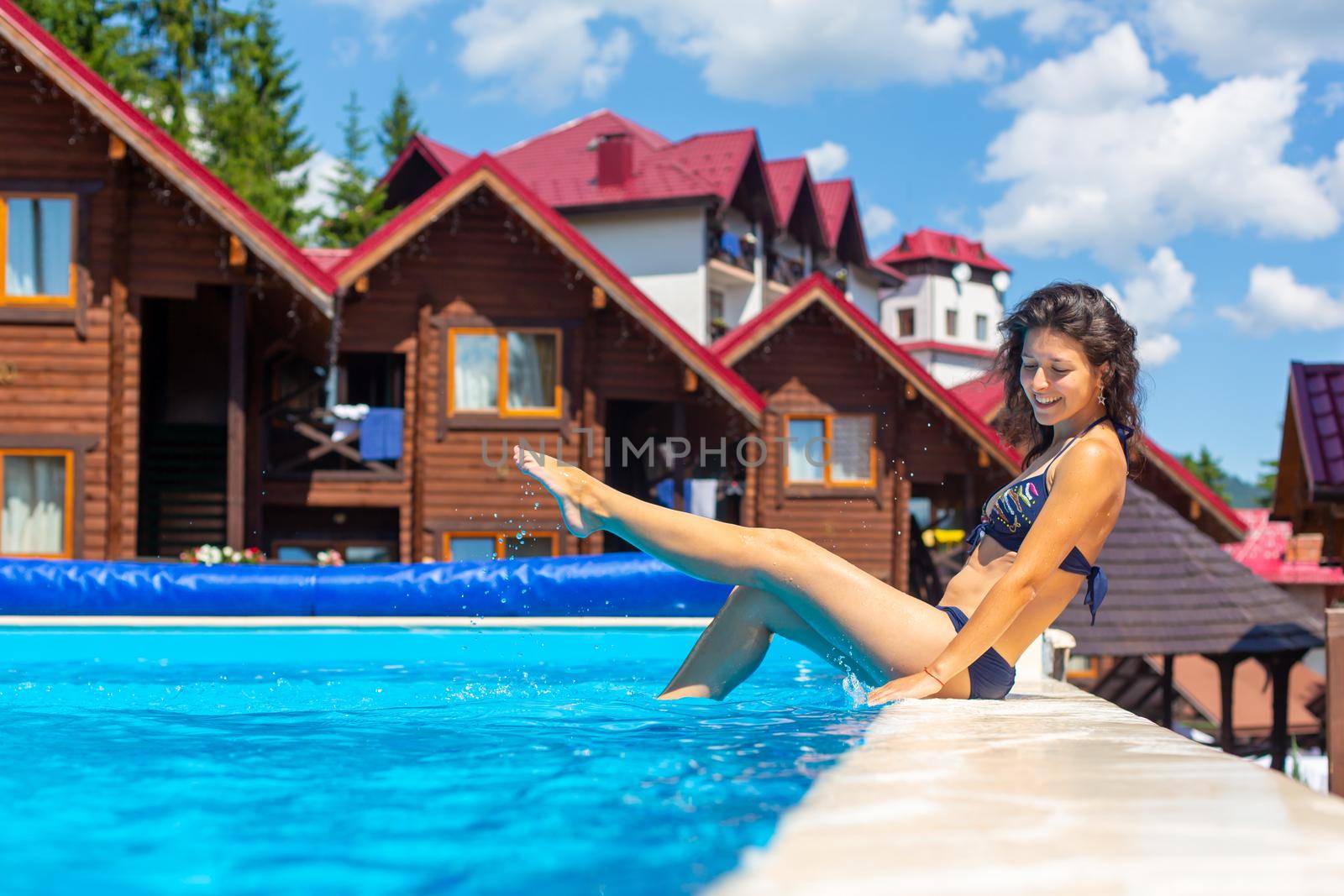 A gorgeous slim girl relax in the pool in hot summer day by Try_my_best