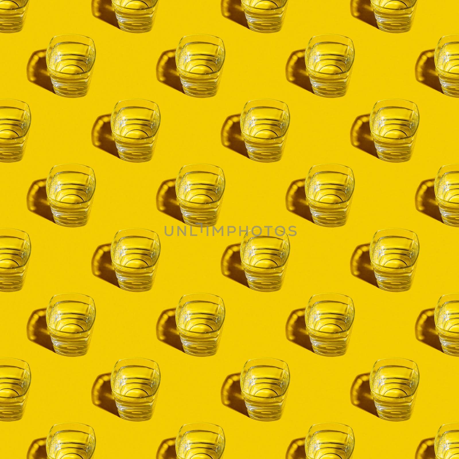 Seamless pattern of glasses with water on a yellow background. For printing posters on fabric.