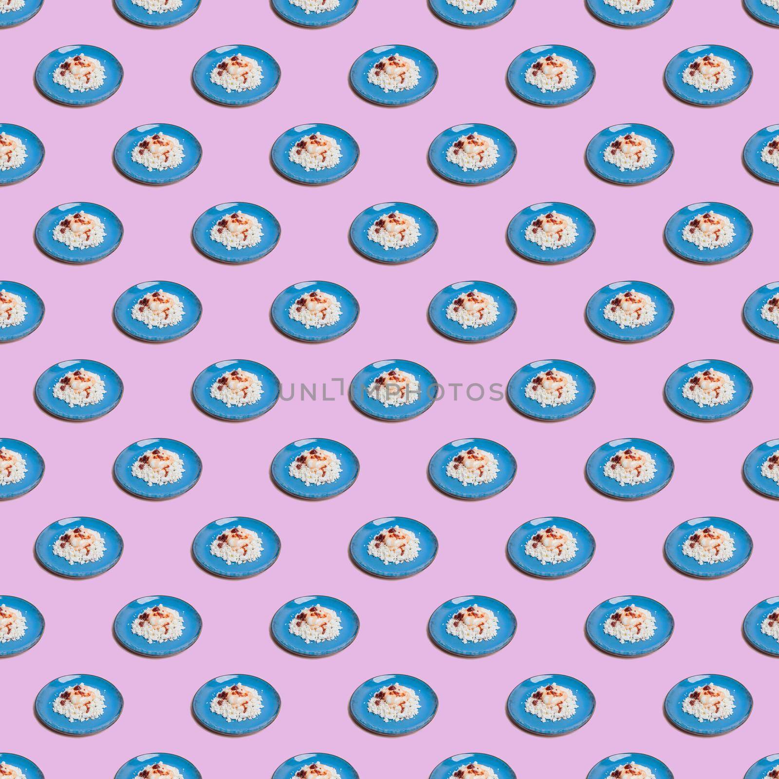 Seamless pattern from blue plates with cottage cheese on a pink background. by Yurich32