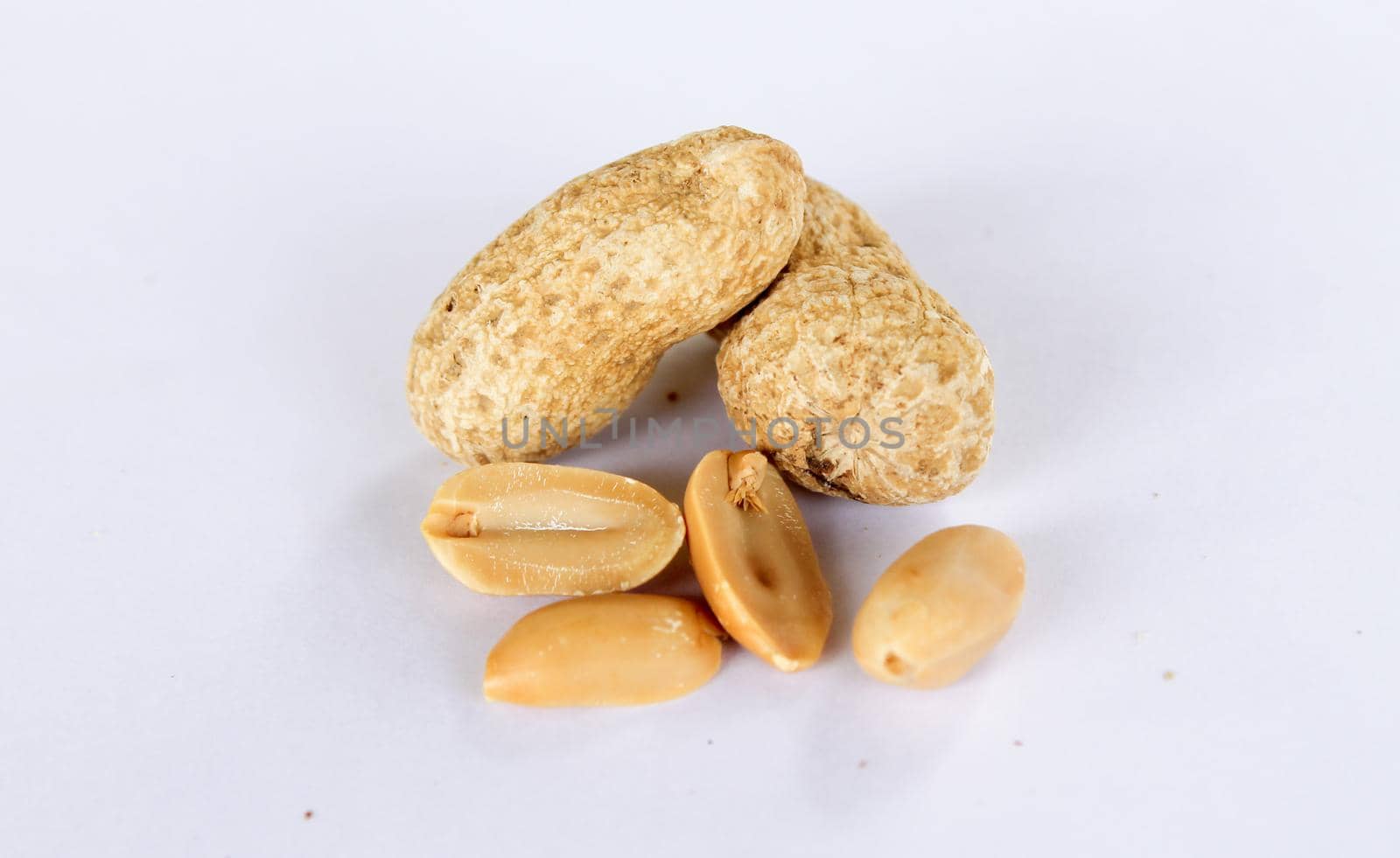 Peanuts isolated on a white background. There are separate peanut kernels. close-up photo by pichai25