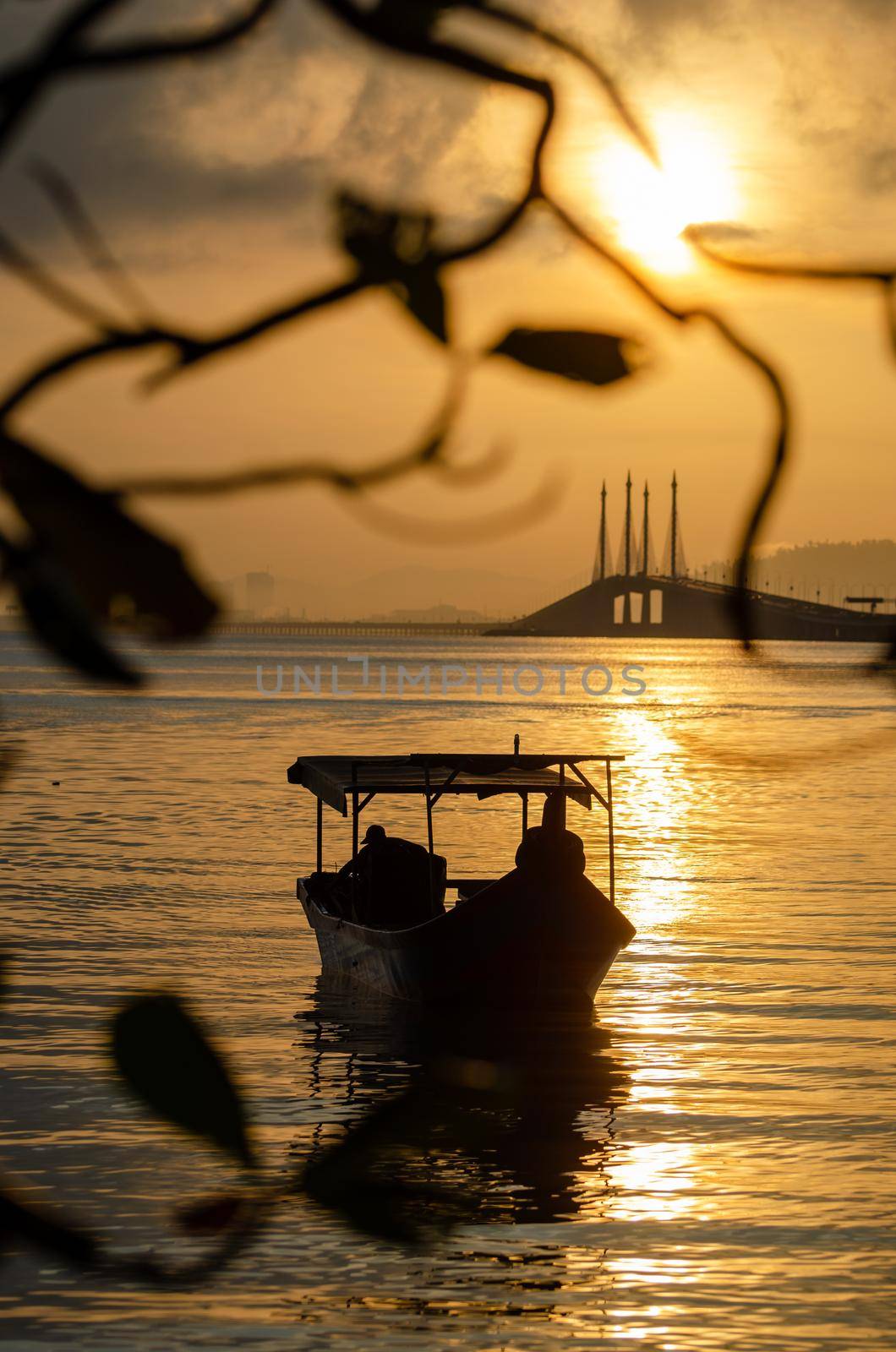 Silhouette a boat with background Penang Bridge.