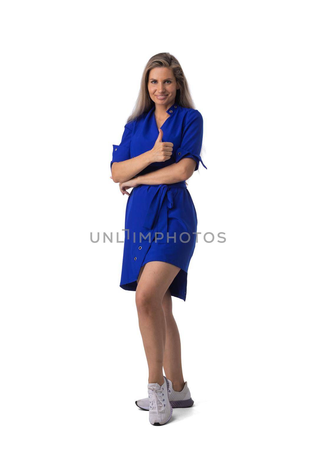 Woman in blue dress full body portrait showing thumb up isolated on white background