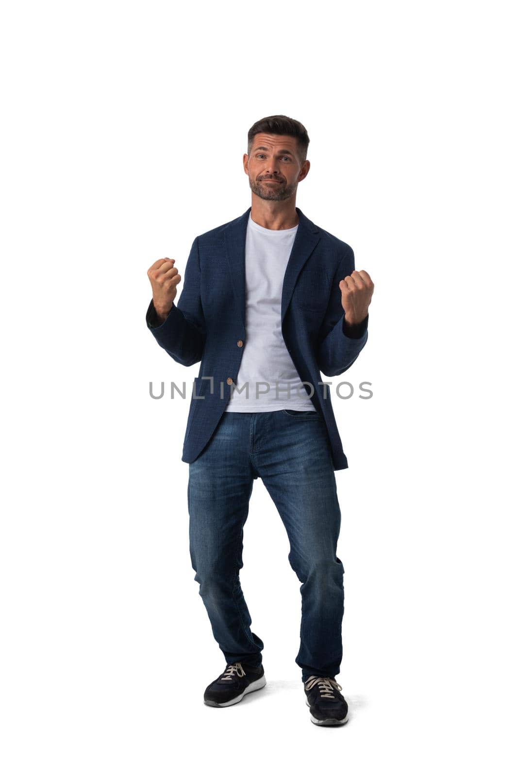 Young business man winner holding fists isolated on white background full length studio portrait