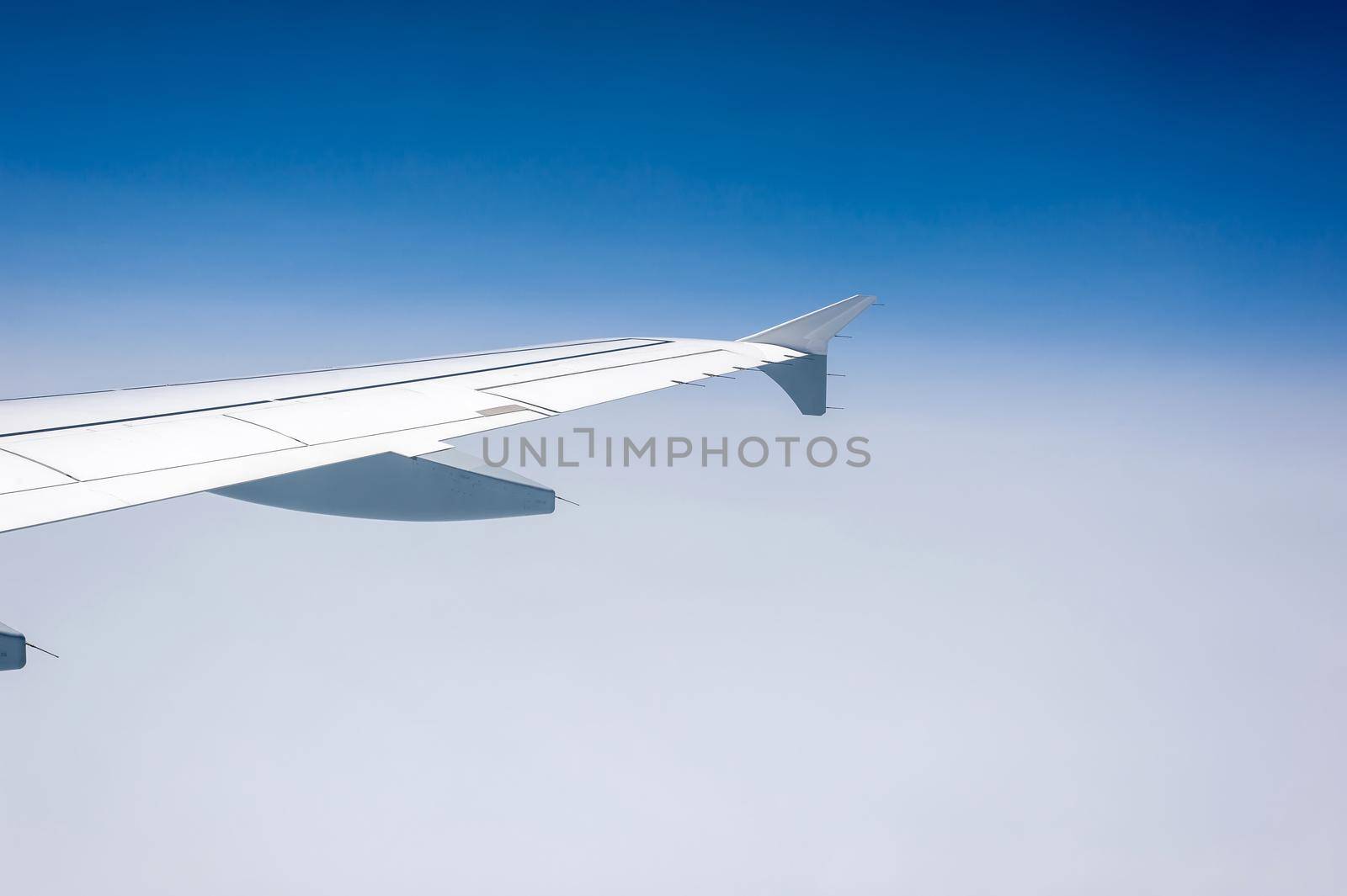 View from airborne airplane window at cloudy sky at high altitude. by Qba