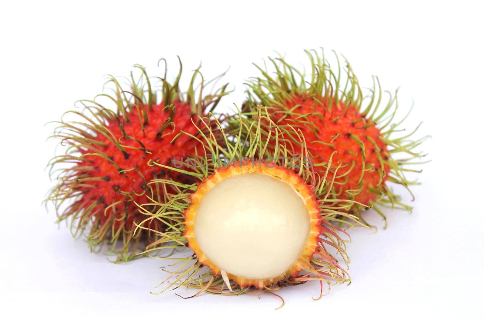 Delicious sweet fruit rambutan isolated on white background, peeled rambutan reveals white fruit pulp inside.