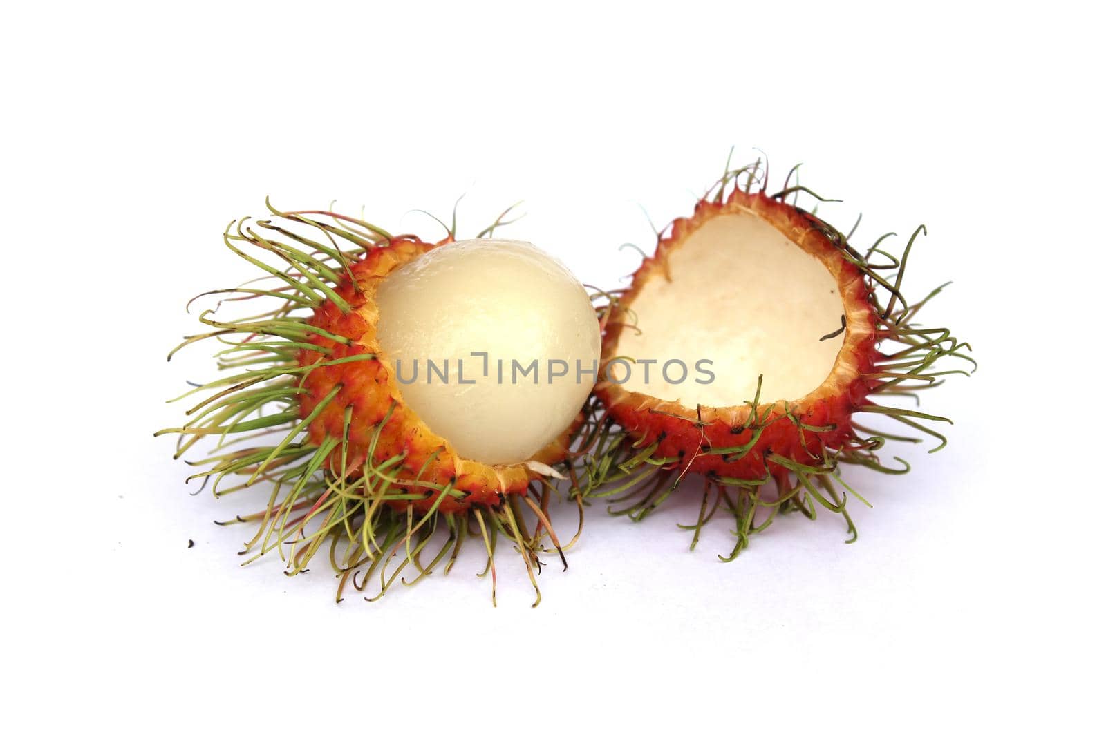 Sweet rambutan, a popular fruit of Thailand, is peeled off to reveal the inside, separated from a white background.