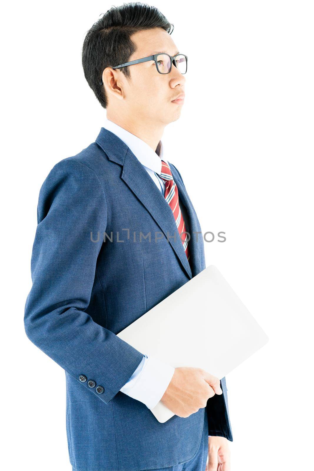 Young asian businessman portrait in suit and wear glasses holding a laptop over white background