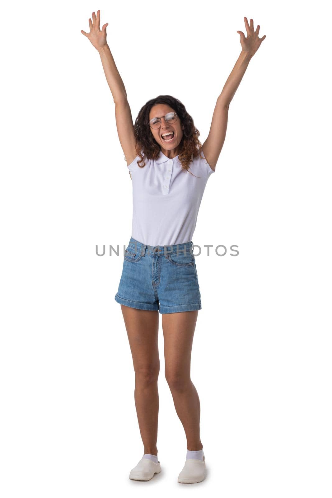 Happy woman with arms raised looking at camera, isolated over white background