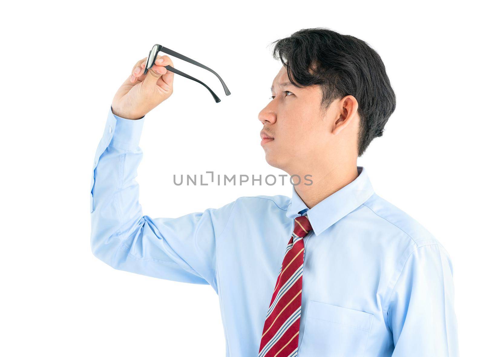 Male wearing blue shirt and red tie holding eyeglasses isolated on white background