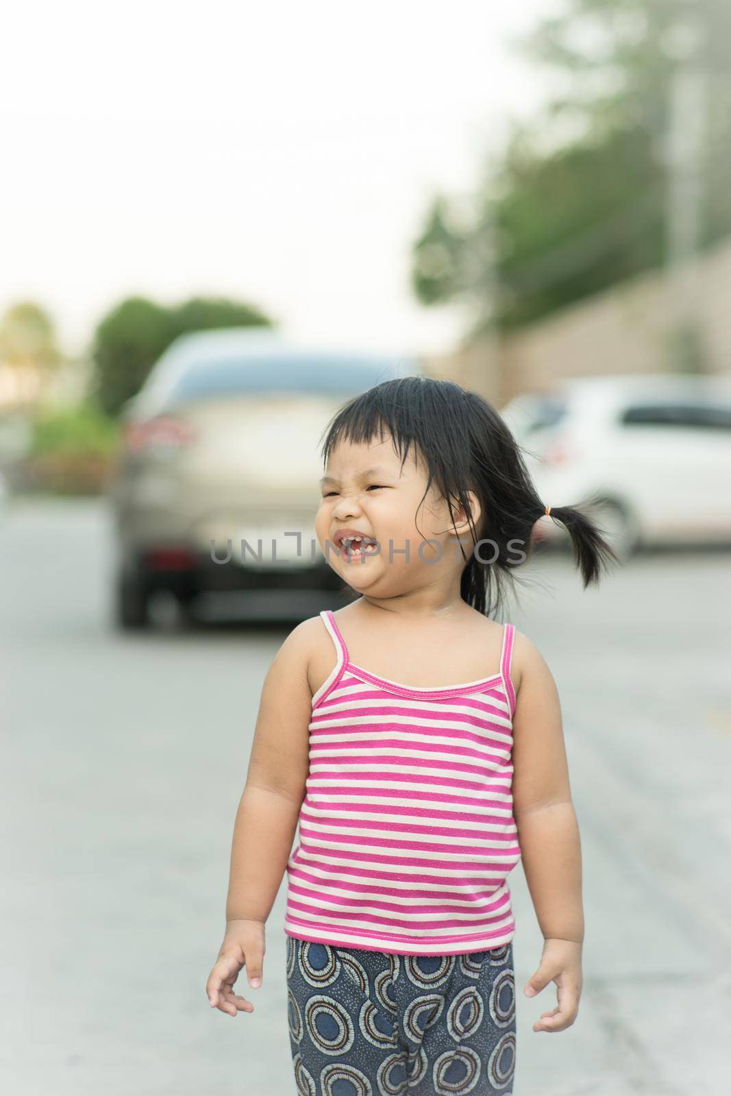 Portrait of asian happy laughing child girl by domonite