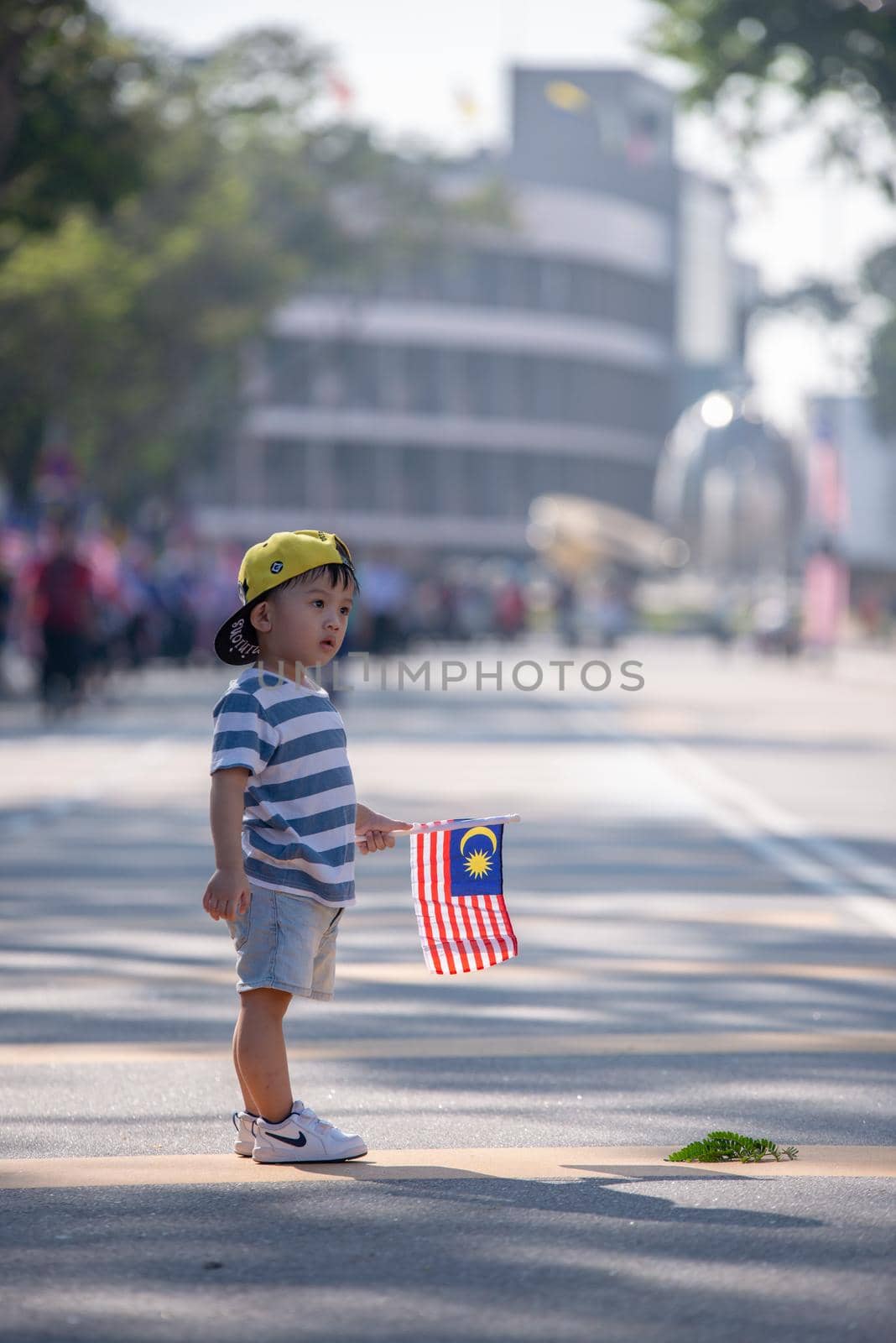 George Town, Penang/Malaysia - Aug 31 2017: A children hold Malaysia flag at street.