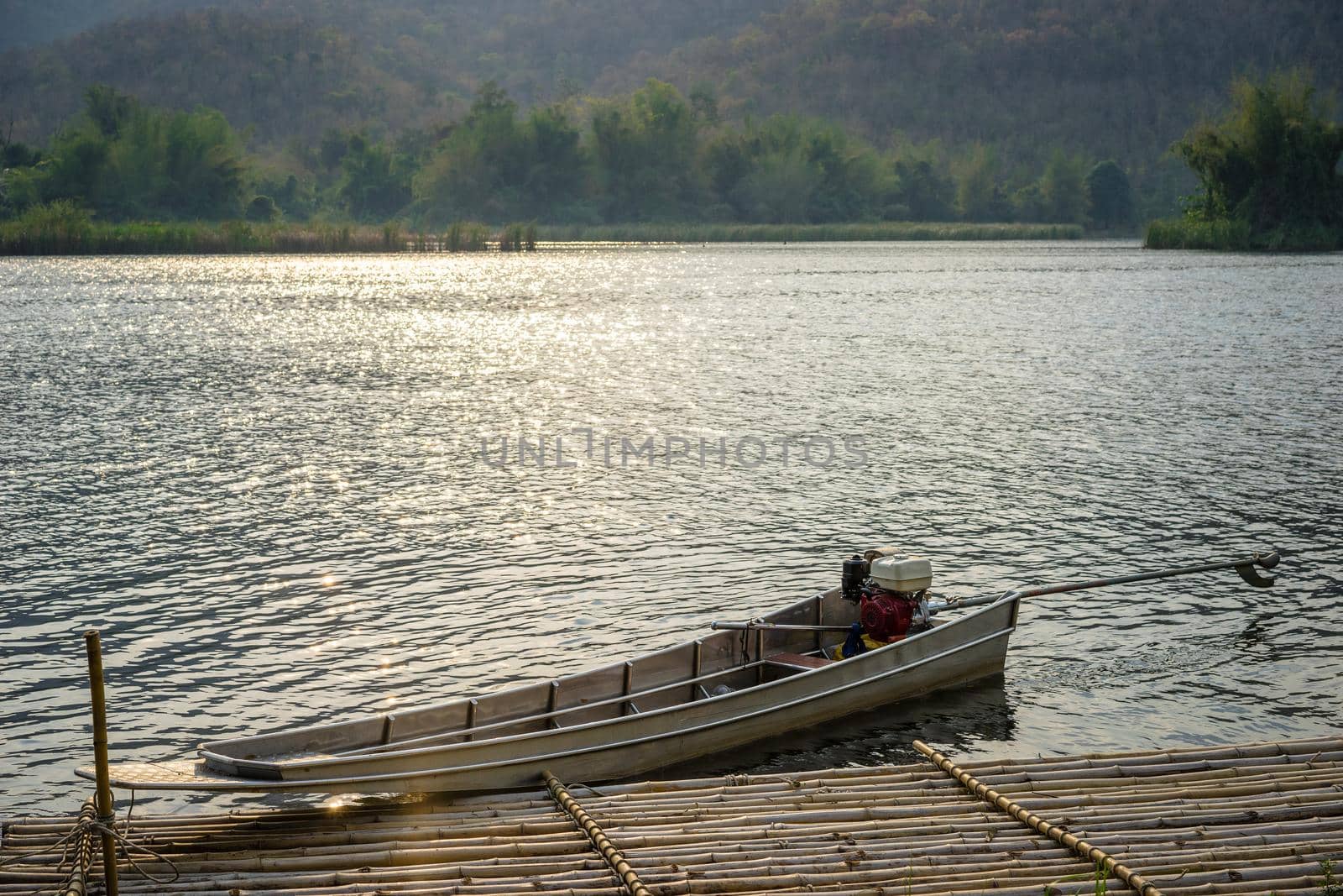 boats docked on a mountain lake with sunlight.Natural dam lake in forest.