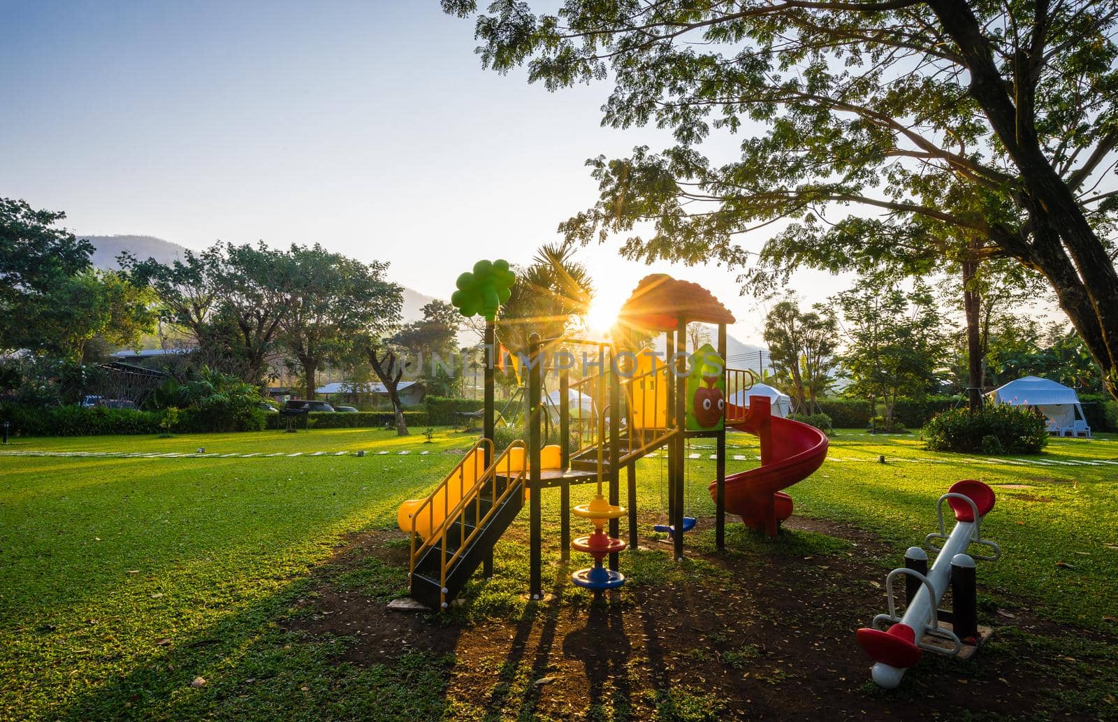 Colorful playground and sunrise  on yard in the park by domonite