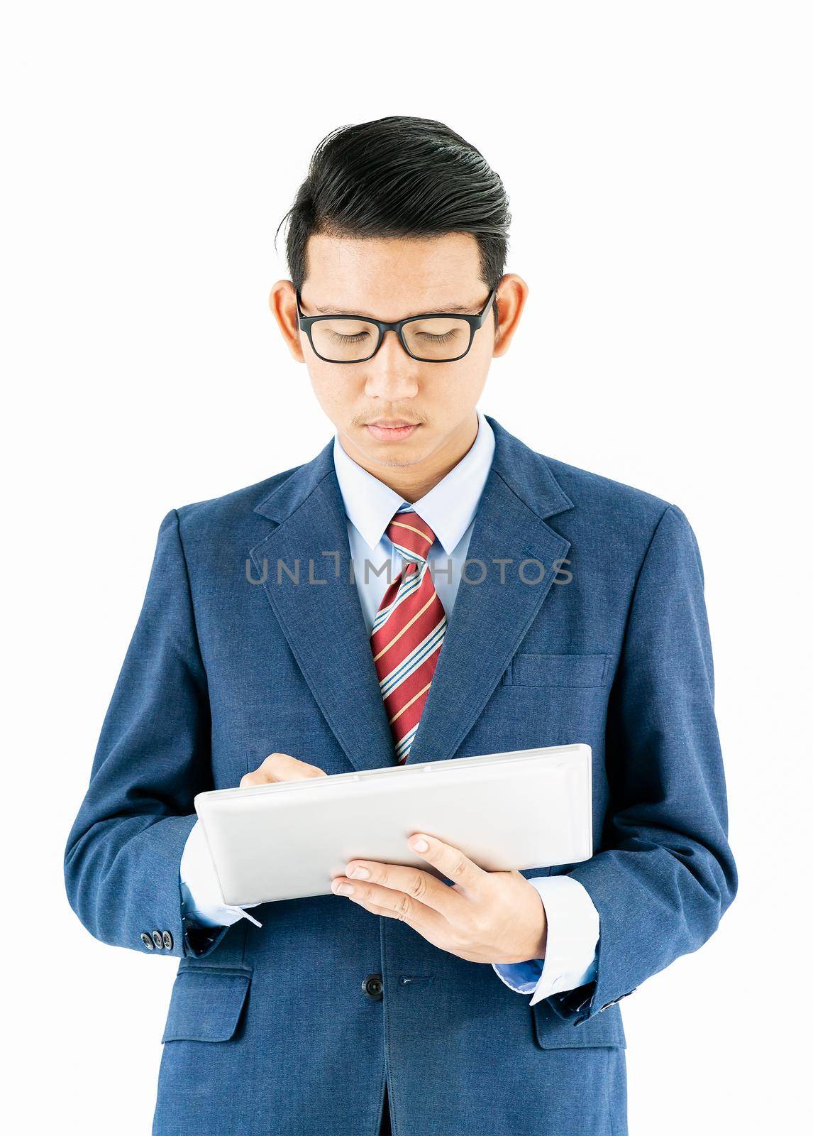 Young asian businessman portrait in suit and wear glasses holding a laptop over white background