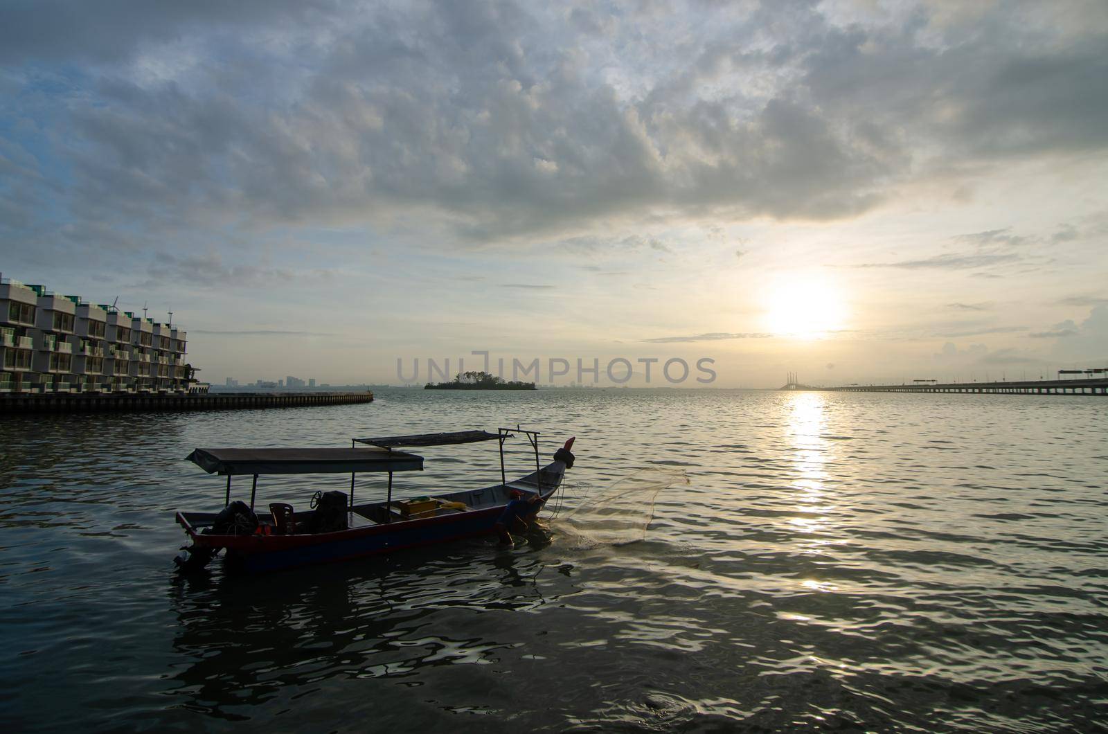 Georgetown, Penang/Malaysia - Feb 15 2020: Silhouette fisherman cast net at Penang sea.