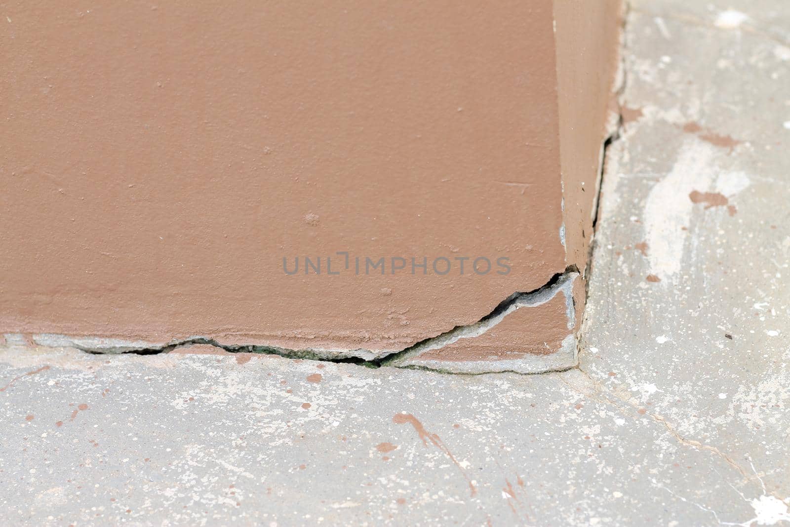 Deep cracks and holes in the exterior concrete wall old brown wall damaged Move or crack concrete. Copy space. by pichai25