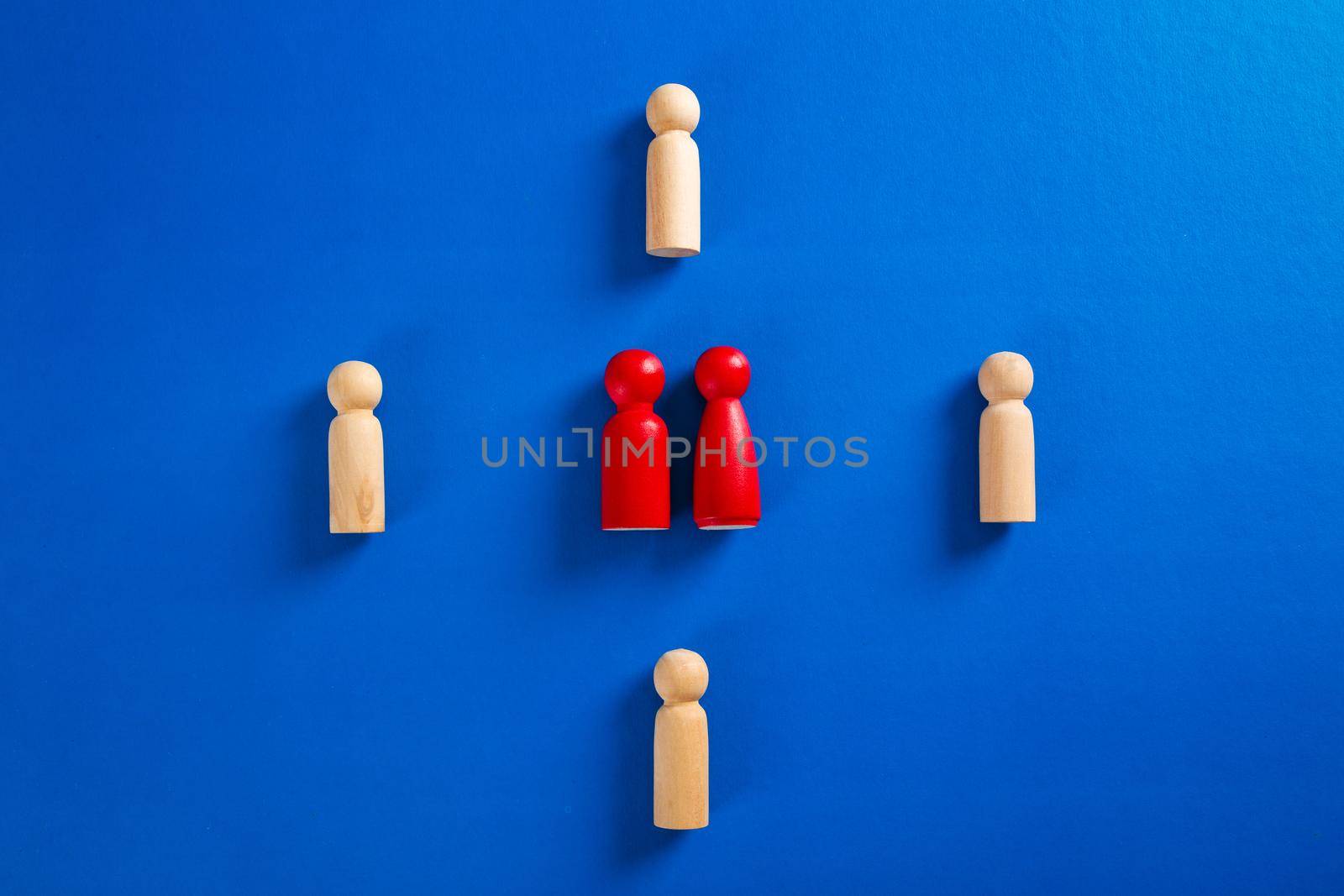 A wooden figure standing with a team to influence and empowerment. by tehcheesiong