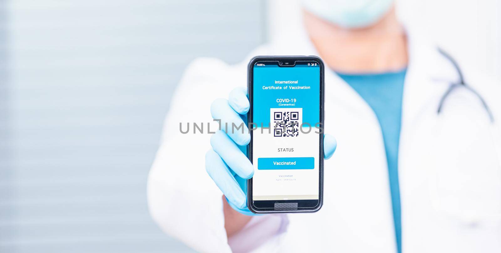 Doctor man in medical mask show app smartphone mobile digital vaccinated passport coronavirus (COVID-19) certificate to confirm, vaccine health pass concept