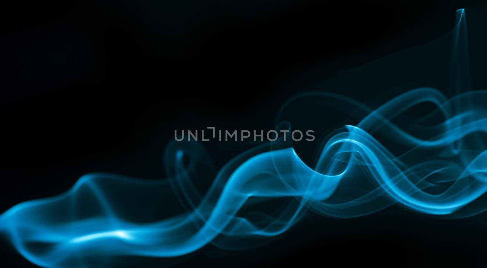 Blue smoke isolated on black background. by thanumporn