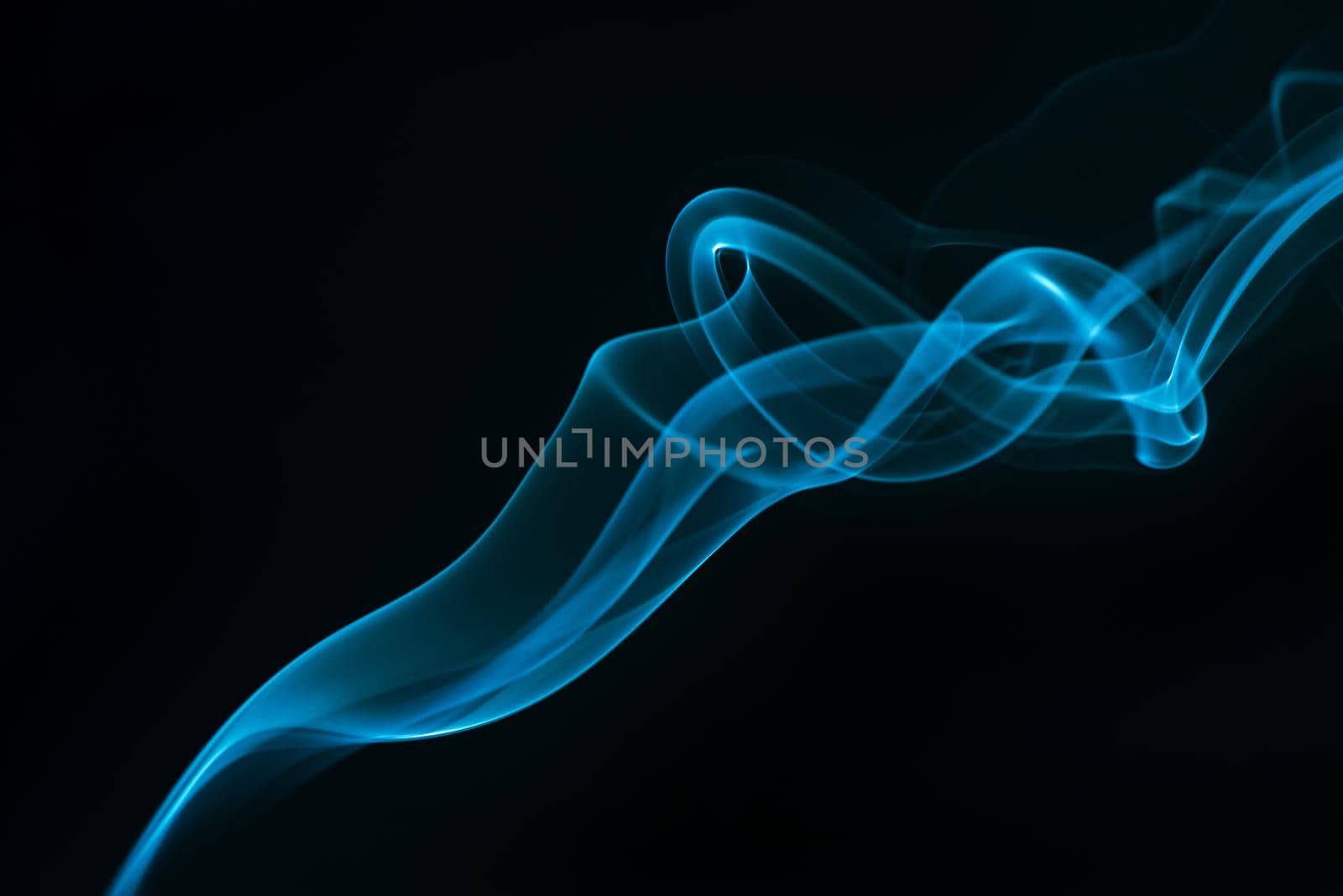 Blue smoke isolated on black background. by thanumporn