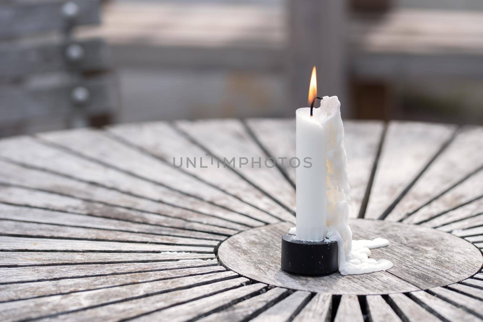 Still life of garden lighting candles on wooden table outdoor