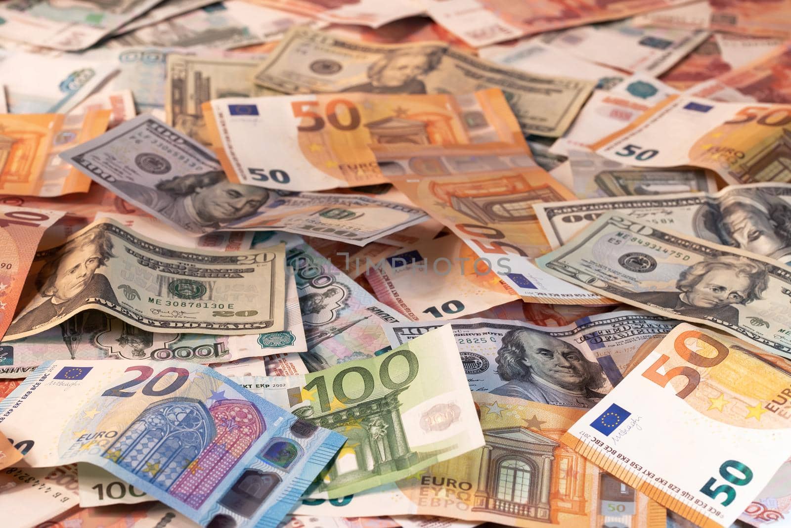 Background made of dollar, euro and russian roubles banknotes on a table