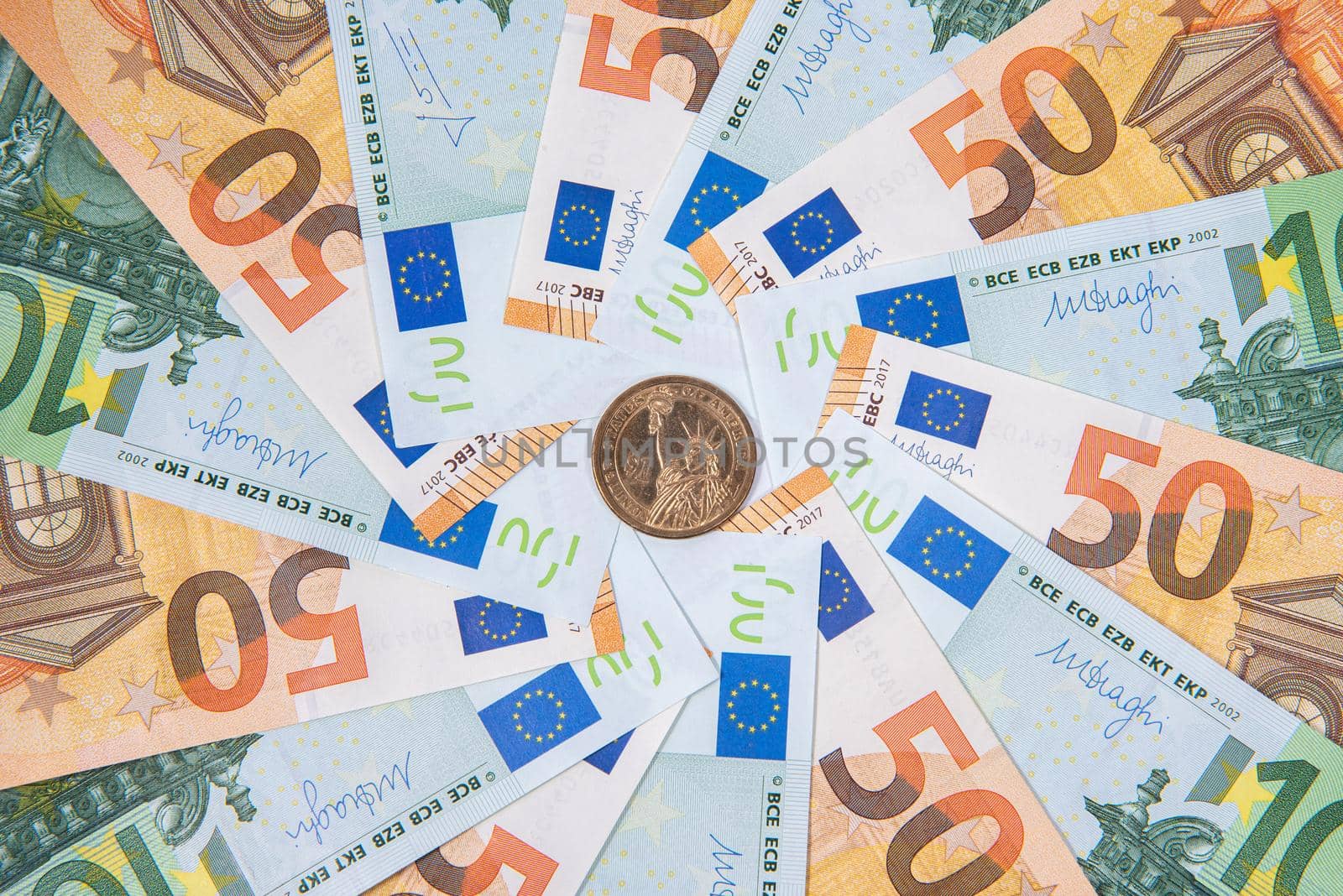 Background made of euro banknotes and dollar coin with liberty statue