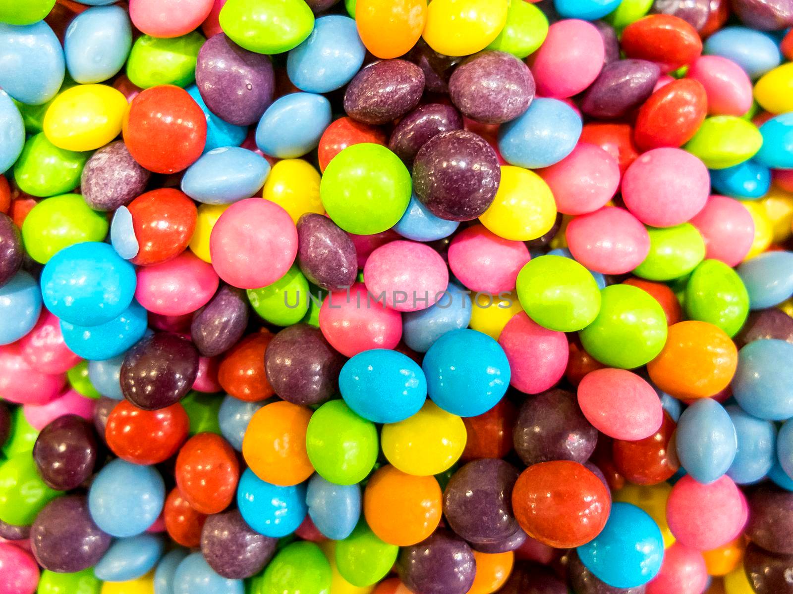 Colorful candies as background, top view