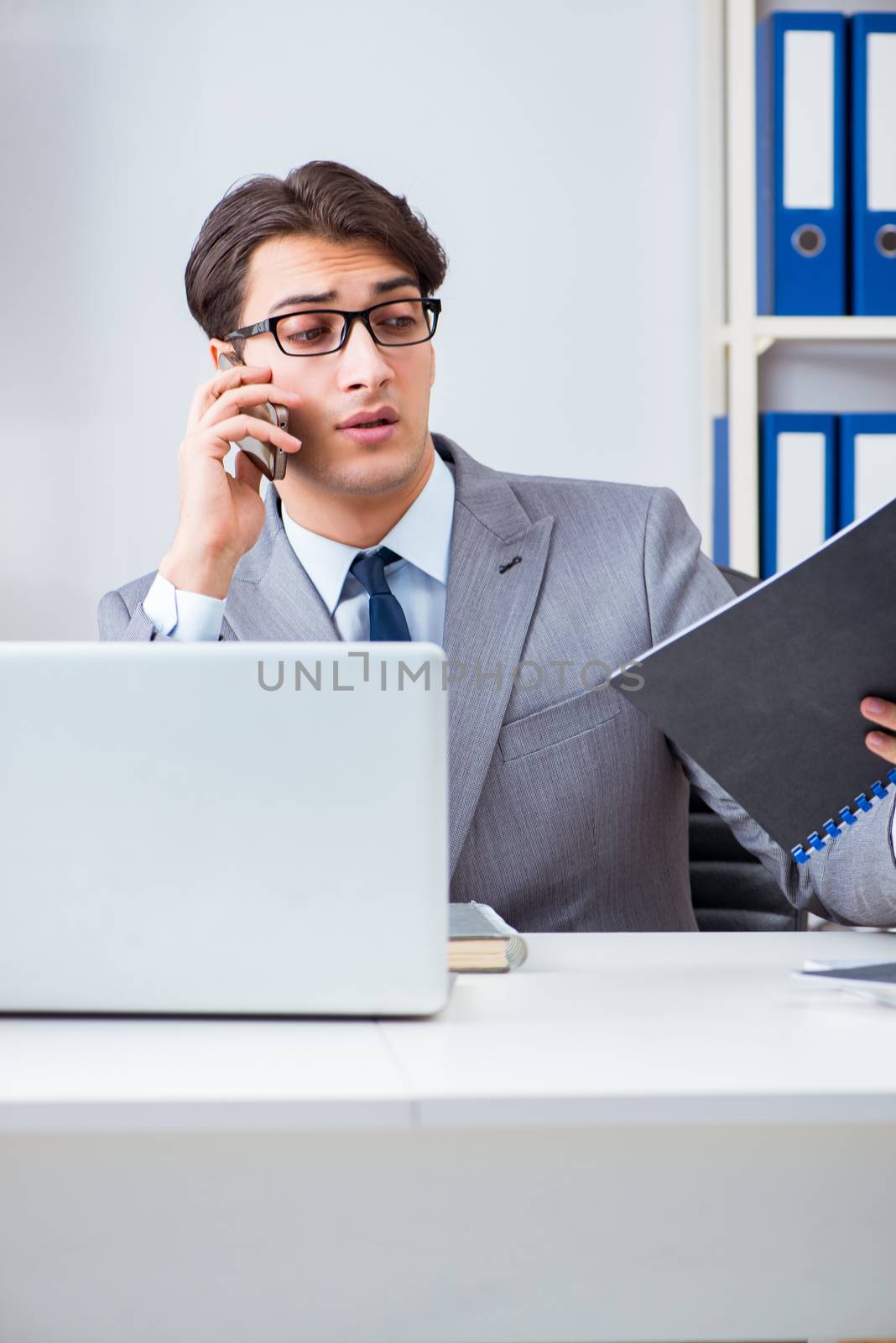 Businessman employee talking on the office phone