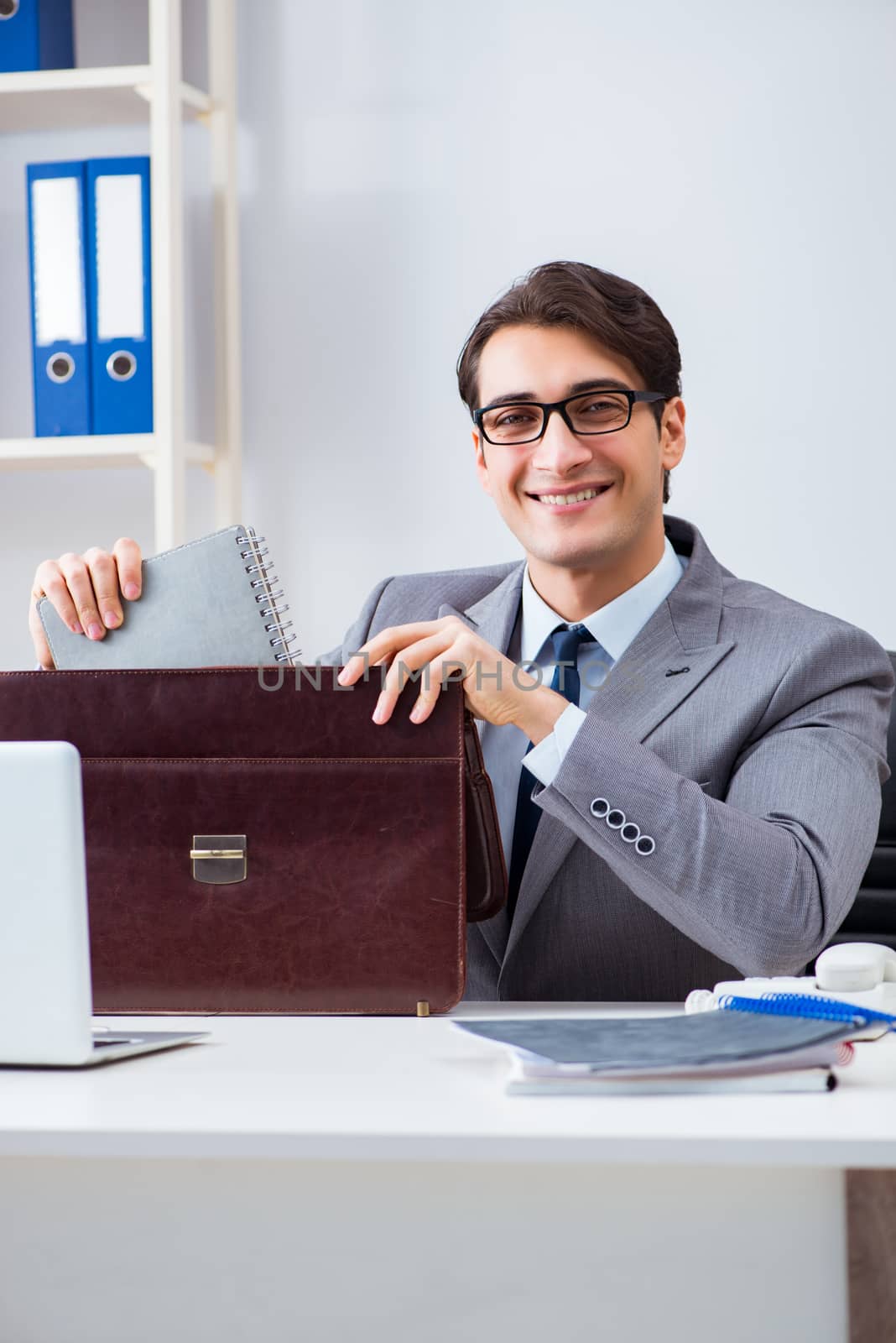 Young handsome businessman employee working in office at desk