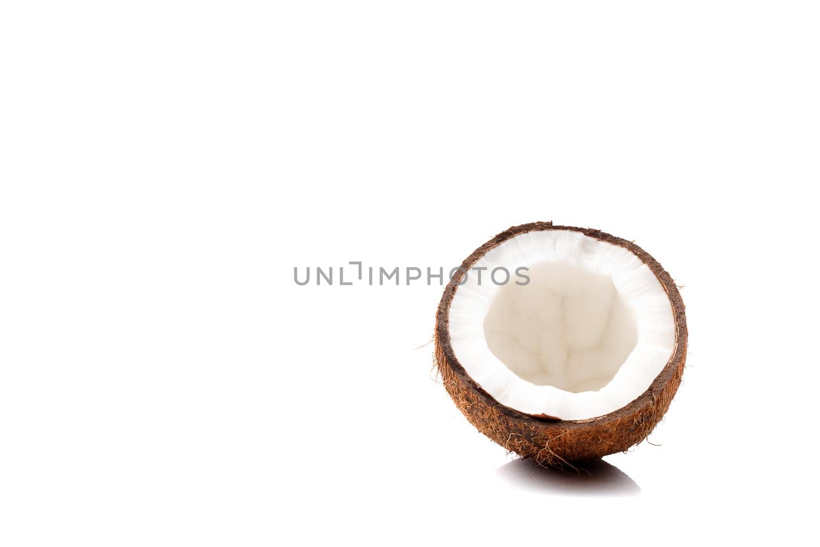 Half of coconut isolated on white background by Estival