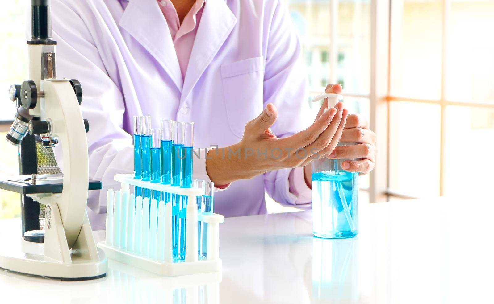 Asian scientist or medical researcher Test concept for producing 75% alcohol-based hand sanitizer for hand washing in case of sterilization of bacteria and preventing the coronavirus, COVID-19