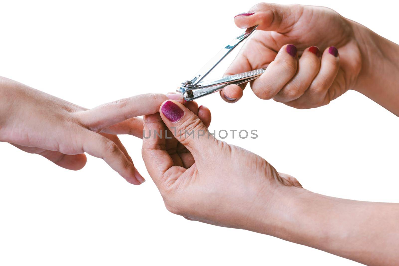 Woman hand is using a nail clipper to cut a child fingernails. by wattanaphob